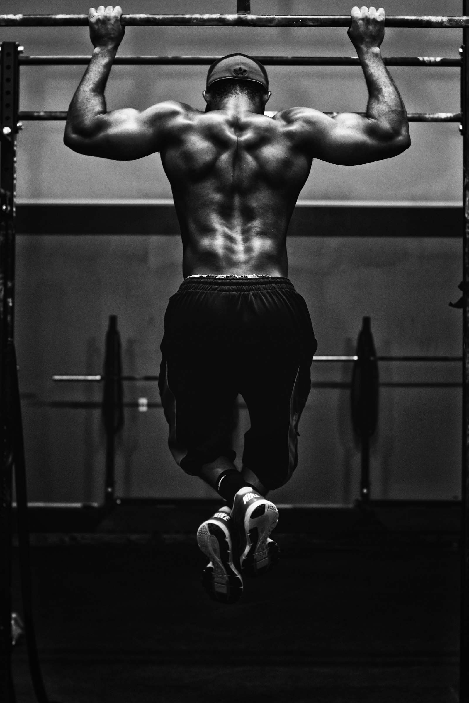 Athlete performing pull-ups in black and white